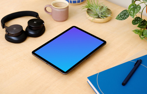 iPad Air mockup on a table surrounded with potted plants