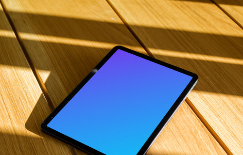 iPad Air mockup on a wooden table in the sunlight