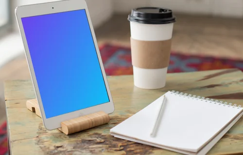 iPad Mini mockup beside a notepad