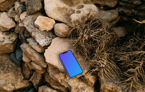 iPhone 13 Pro mockup on stacked rocks