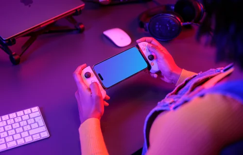 iPhone 15 Pro mockup in a gamer's hand with neon lighting