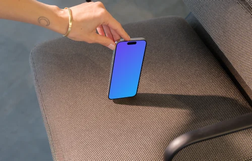 iPhone 15 Pro mockup in a modern office chair