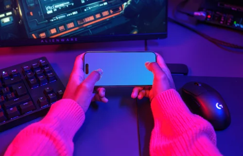 iPhone 15 Pro mockup in a neon gaming setup