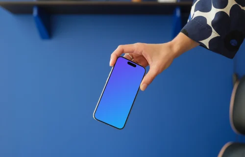 iPhone 15 Pro mockup in a woman's hand against a blue background