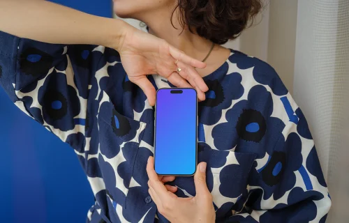 iPhone 15 Pro mockup in a woman's hand with floral outfit