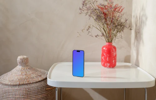 iPhone 15 Pro mockup on a cozy home table with flowers