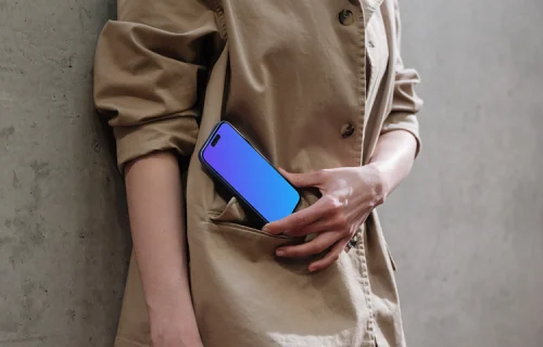 iPhone 16 mockup in woman's hand on concrete background