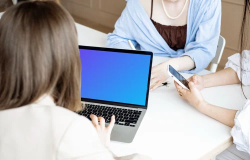 Lady typing on a MacBook Pro mockup in a meeting