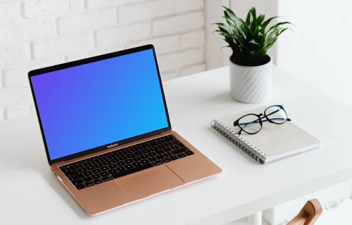 MacBook Air mockup beside a white notebook