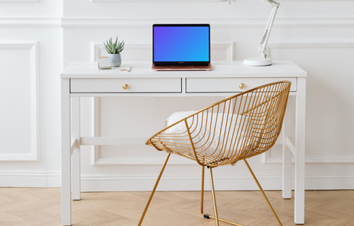 MacBook Air mockup on a table beside a reading lamp