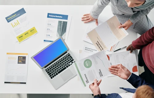 MacBook Air mockup on a table in a business meeting