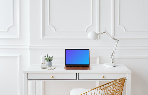 MacBook Air mockup with a white reading lamp at its side.