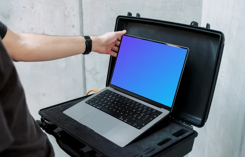 MacBook Pro 14 Mockup with Man Setting Up Display