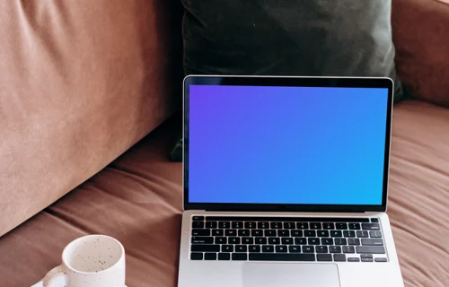 MacBook Pro mockup beside a coffee mug