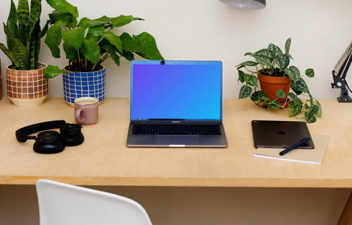 MacBook Pro mockup on a table with an iPad at the side.