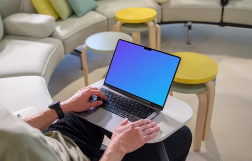 MacBook Pro mockup with a man in a casual workspace