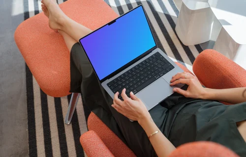 MacBook Pro mockup with a woman relaxing on a chair
