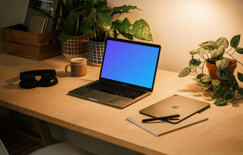 MacBook Pro on table with a pen and an iPad Air at the side