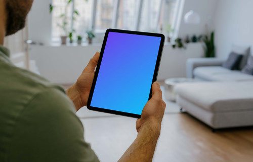 Man holding up an iPad Air mockup