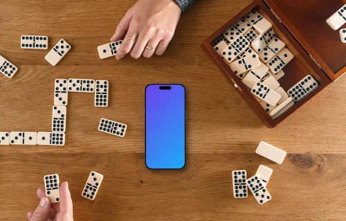 People playing dominoes next to the iPhone mockup