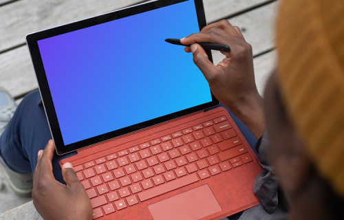 Red Microsoft Surface Laptop mockup held in a users lap