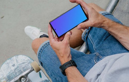 Skateboarder holding a phone mockup