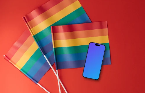 Smartphone mockup atop three rainbow flags