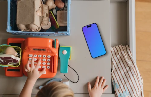 Smartphone mockup beside children's play area