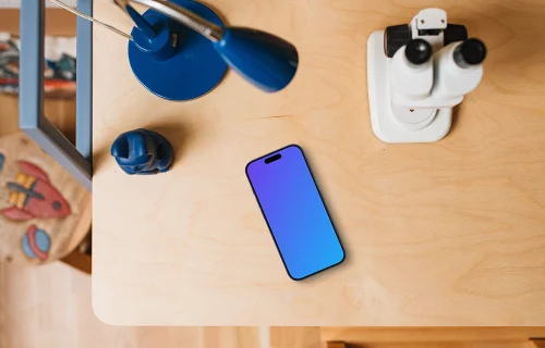 Smartphone mockup on a child's creative table