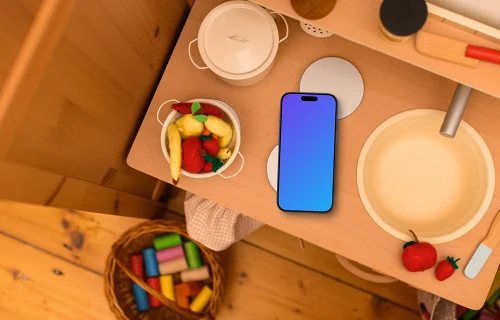 Smartphone mockup on a kid's creative table