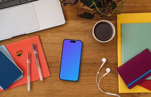 Smartphone mockup on a wooden table together with LGBT pin