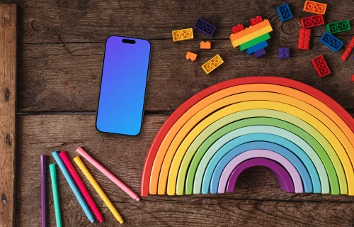 Smartphone mockup on a wooden table with rainbow items