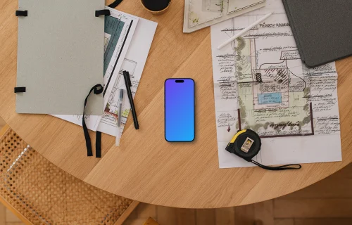 Smartphone mockup on architectural blueprints