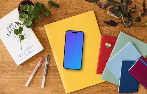 Smartphone mockup placed on colorful notebooks