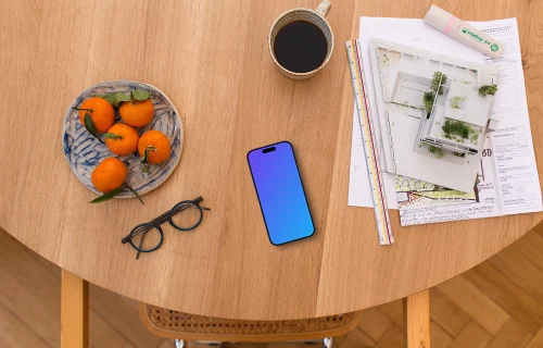 Smartphone mockup with architect's plans and coffee