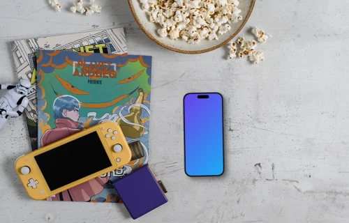 Smartphone mockup with gaming handheld and snacks