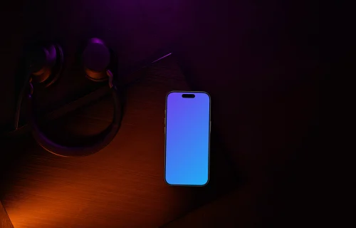 Smartphone mockup with headphones on dark desk