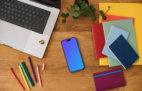 Smartphone mockup with rainbow pens and notebooks