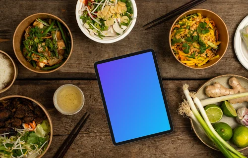 Tablet mockup in the middle of Vietnamese cuisine dishes