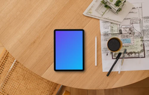 Tablet mockup on architect's desk with blueprints