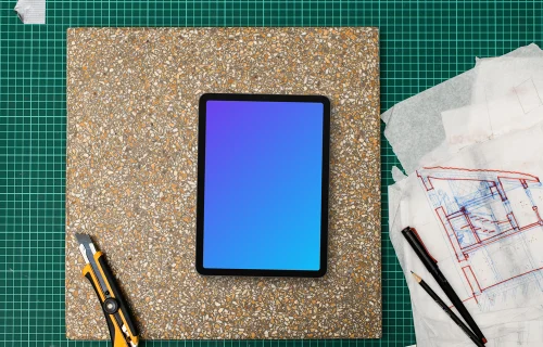 Tablet mockup on architect's table with drafting tools