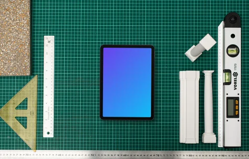 Tablet mockup with architect's tools on drafting table