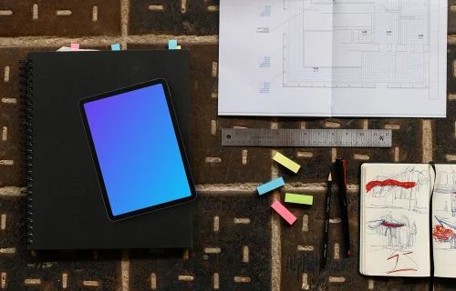 Tablet mockup with architectural blueprint and sketchbook