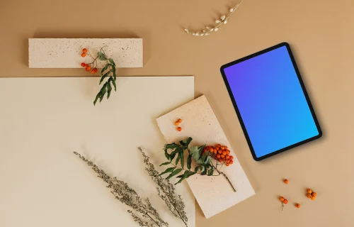 Top view of tablet mockup next to the blank paper