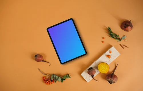 Top view of tablet mockup on the light orange background