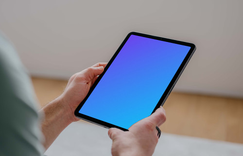 User holding an iPad Air mockup