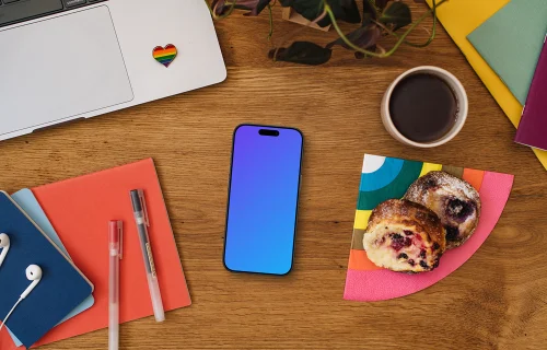 Work desk with a smartphone mockup and pride decorations