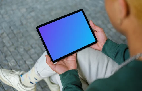 Young man holding iPad mockup