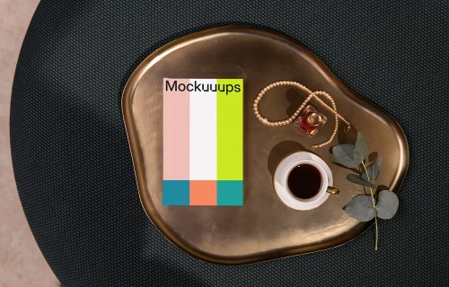 A-format book mockup on a golden tray with coffee and accessories