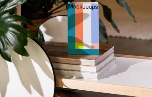 A-format book mockup on a wooden shelf with decor